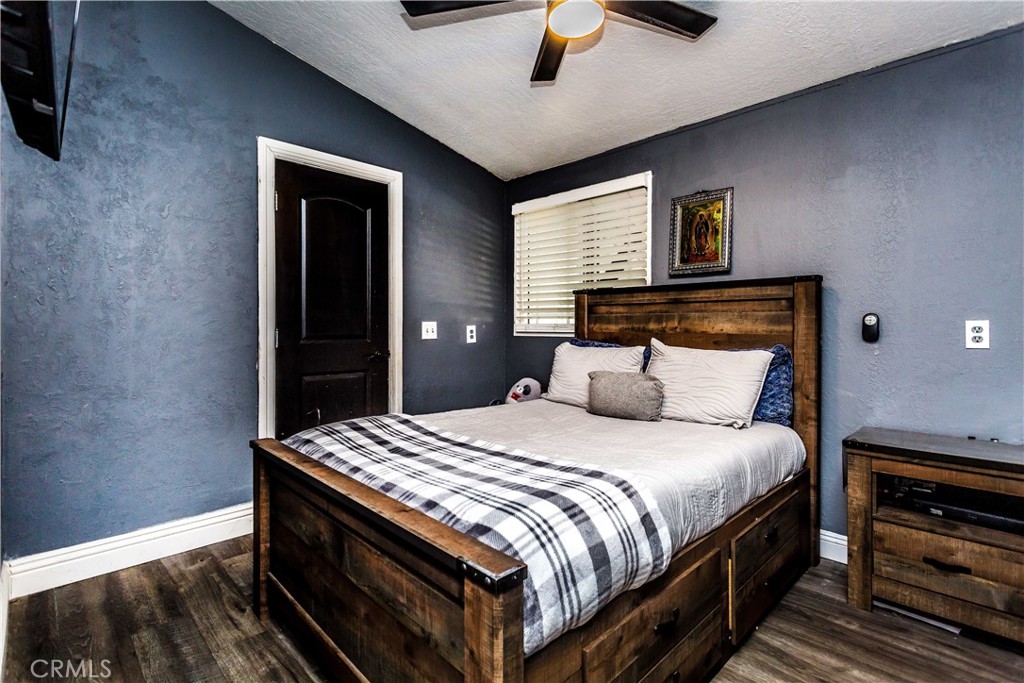 3050 West Ball Road, Unit 200 Anaheim, CA 92804 - Photo 9 of 21 a bedroom with a bed and a chandelier