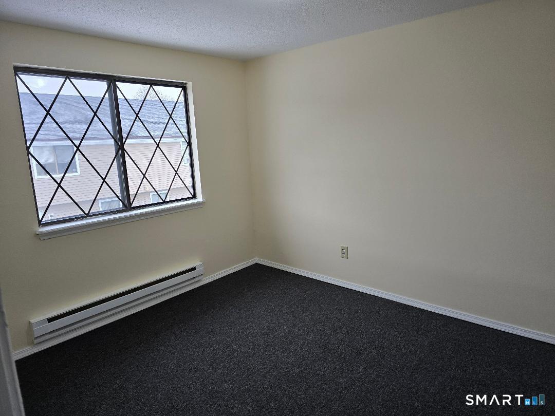 1440 Meriden Road, Unit 7 Waterbury, CT 06705 - Photo 4 of 6 an empty room with a window