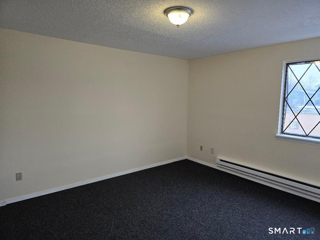 1440 Meriden Road, Unit 7 Waterbury, CT 06705 - Photo 5 of 6 an empty room with a window