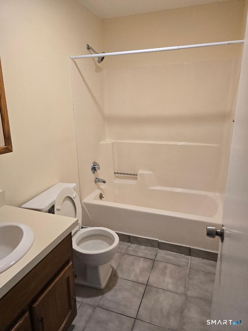 1440 Meriden Road, Unit 7 Waterbury, CT 06705 - Photo 6 of 6 a bathroom with a sink a toilet and shower