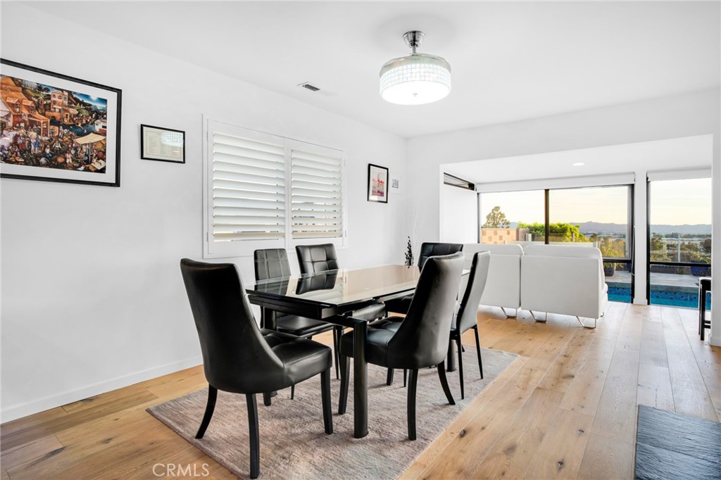 10208 Sully Drive Sun Valley, CA 91352 - Photo 19 of 44 a view of a dining room with furniture and wooden floor
