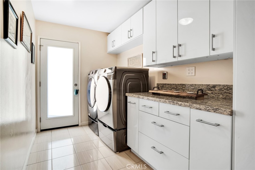 10208 Sully Drive Sun Valley, CA 91352 - Photo 7 of 44 a kitchen with granite countertop a sink a stove and cabinets