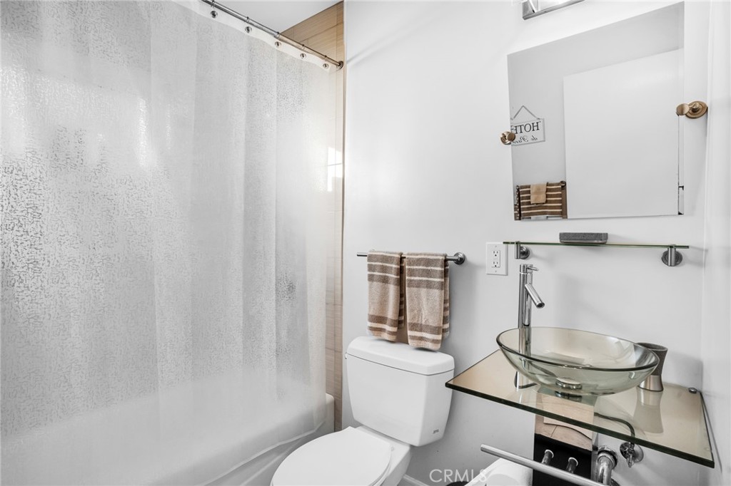 10208 Sully Drive Sun Valley, CA 91352 - Photo 9 of 44 a bathroom with a granite countertop sink toilet and a mirror