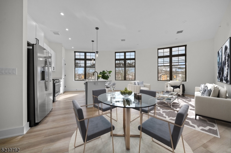 1 Union Avenue, Unit 207 Cresskill, NJ 07626 - Photo 1 of 49 a dining room with furniture and wooden floor