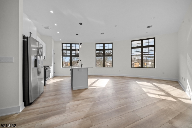 1 Union Avenue, Unit 207 Cresskill, NJ 07626 - Photo 14 of 49 an empty room with wooden floor and windows
