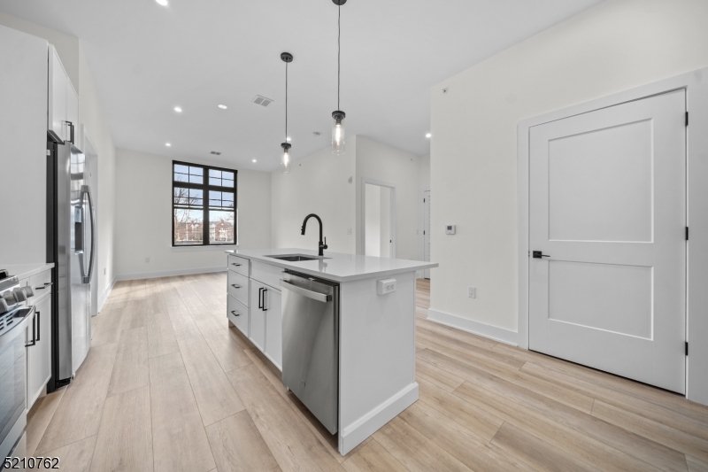 1 Union Avenue, Unit 207 Cresskill, NJ 07626 - Photo 20 of 49 a kitchen with stainless steel appliances granite countertop a stove and a refrigerator