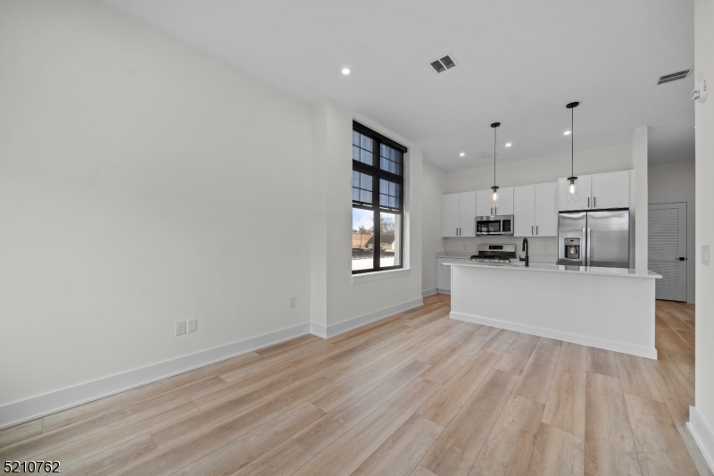 1 Union Avenue, Unit 207 Cresskill, NJ 07626 - Photo 21 of 49 a view of kitchen with stainless steel appliances cabinets and wooden floor