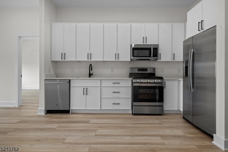 1 Union Avenue, Unit 207 Cresskill, NJ 07626 - Photo 25 of 49 a kitchen with stainless steel appliances white cabinets and a refrigerator