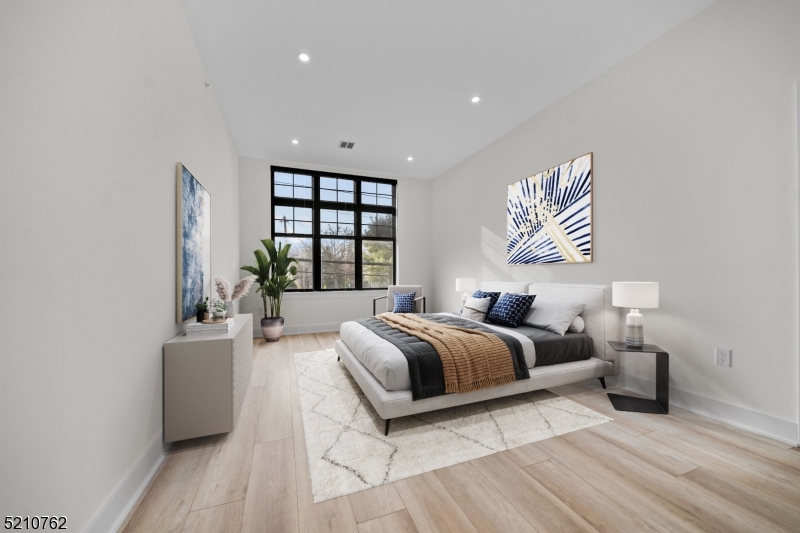 1 Union Avenue, Unit 207 Cresskill, NJ 07626 - Photo 31 of 49 a spacious bedroom with a bed and a couch
