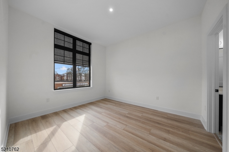 1 Union Avenue, Unit 207 Cresskill, NJ 07626 - Photo 32 of 49 an empty room with wooden floor and windows