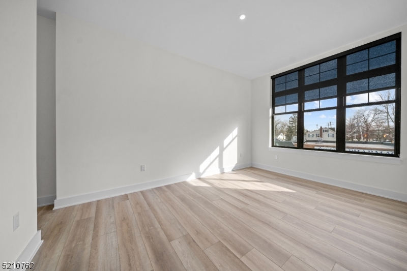 1 Union Avenue, Unit 207 Cresskill, NJ 07626 - Photo 36 of 49 an empty room with wooden floor and windows