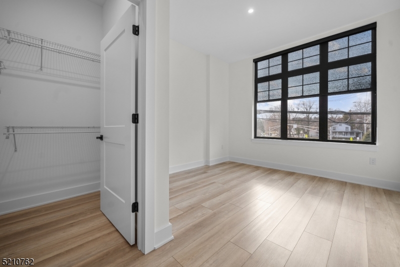 1 Union Avenue, Unit 207 Cresskill, NJ 07626 - Photo 38 of 49 wooden floor in an empty room with a window