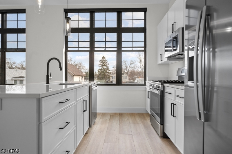 1 Union Avenue, Unit 207 Cresskill, NJ 07626 - Photo 7 of 49 a kitchen with granite countertop a refrigerator and a sink