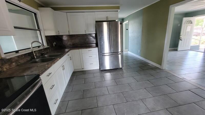 1666 Terrace Street Cocoa, FL 32922 - Photo 11 of 24 a kitchen with stainless steel appliances granite countertop a refrigerator a sink and a stove