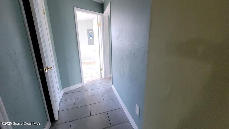 1666 Terrace Street Cocoa, FL 32922 - Photo 17 of 24 a view of hallway with a sink and a mirror