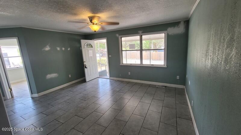 1666 Terrace Street Cocoa, FL 32922 - Photo 20 of 24 an empty room with wooden floor and a window