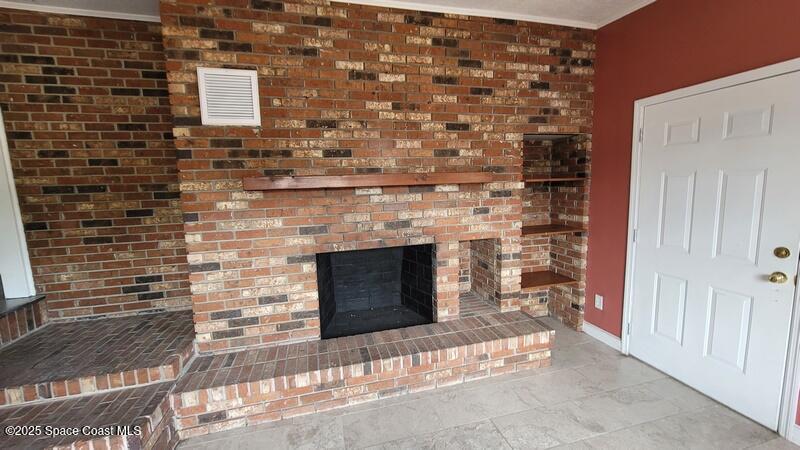 1666 Terrace Street Cocoa, FL 32922 - Photo 22 of 24 a living room with a fireplace
