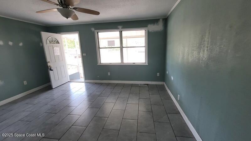 1666 Terrace Street Cocoa, FL 32922 - Photo 8 of 24 an empty room with wooden floor and windows