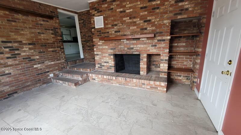 1666 Terrace Street Cocoa, FL 32922 - Photo 9 of 24 a view of fireplace and an empty room
