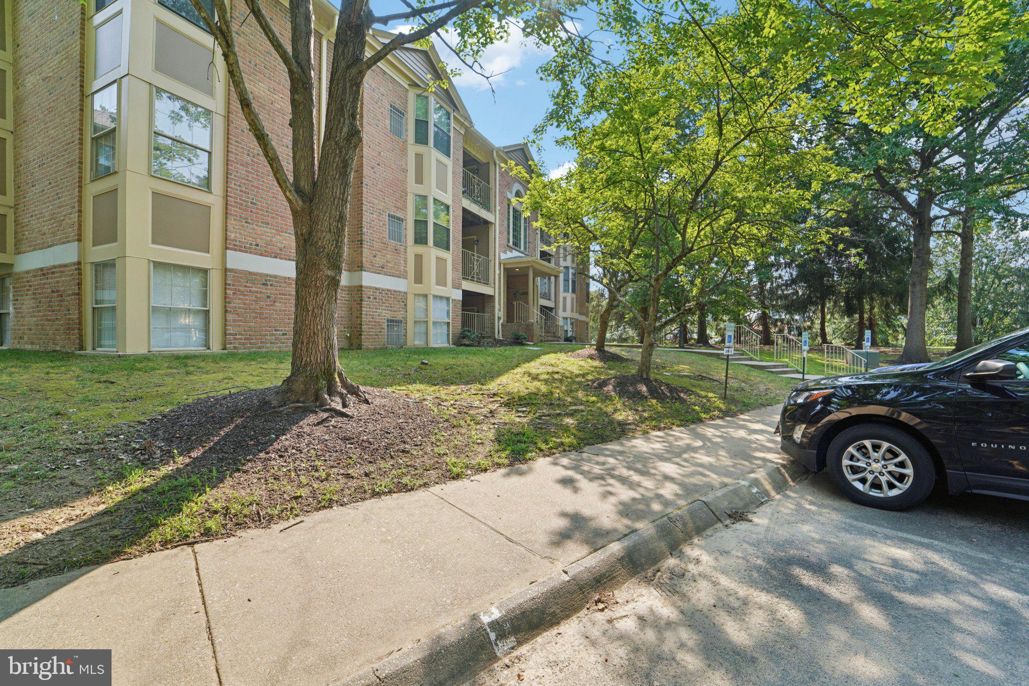 3500 Thomas Pointe Court, Unit 2B Abingdon, MD 21009 - Photo 34 of 37 a car parked in front of a brick house with a yard