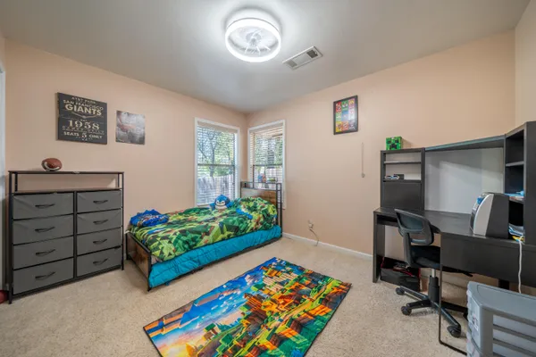 a bedroom with a bed and a large mirror