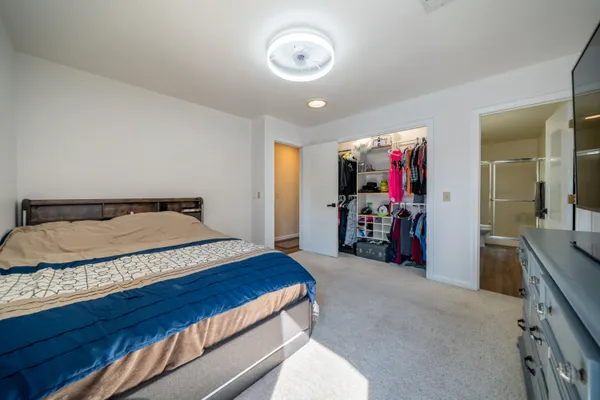 a bedroom with a bed and a flat screen tv