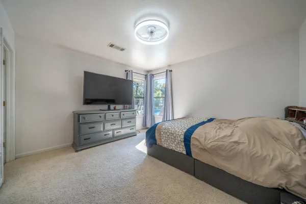 a bathroom with a sink a toilet a mirror and shower
