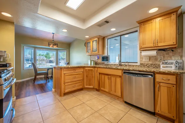 a kitchen with granite countertop cabinets and appliances