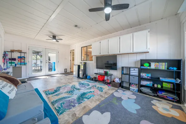 a view of game room with window and wooden floor