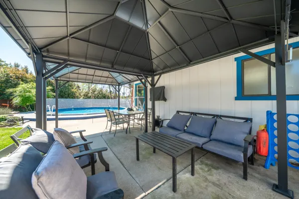 a front view of house with yard and outdoor seating