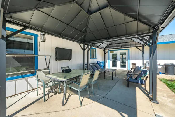 a front view of house with yard and outdoor seating