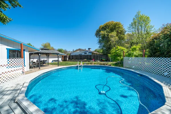 a view of a house with backyard and porch