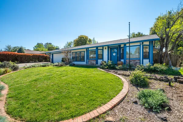 an aerial view of a house with swimming pool garden and patio