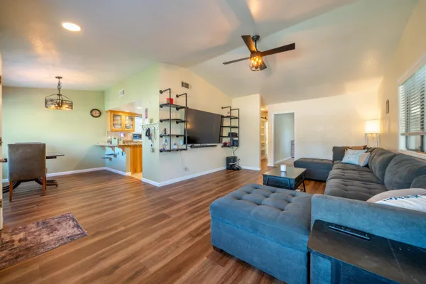 a view of a room with lots of stuff and hardwood floor