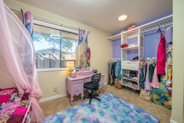 a bedroom with furniture and a window