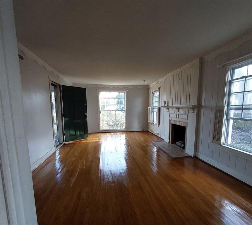 325 West 4th Street Tyler, TX 75701 - Photo 24 of 40 an empty room with wooden floor and windows