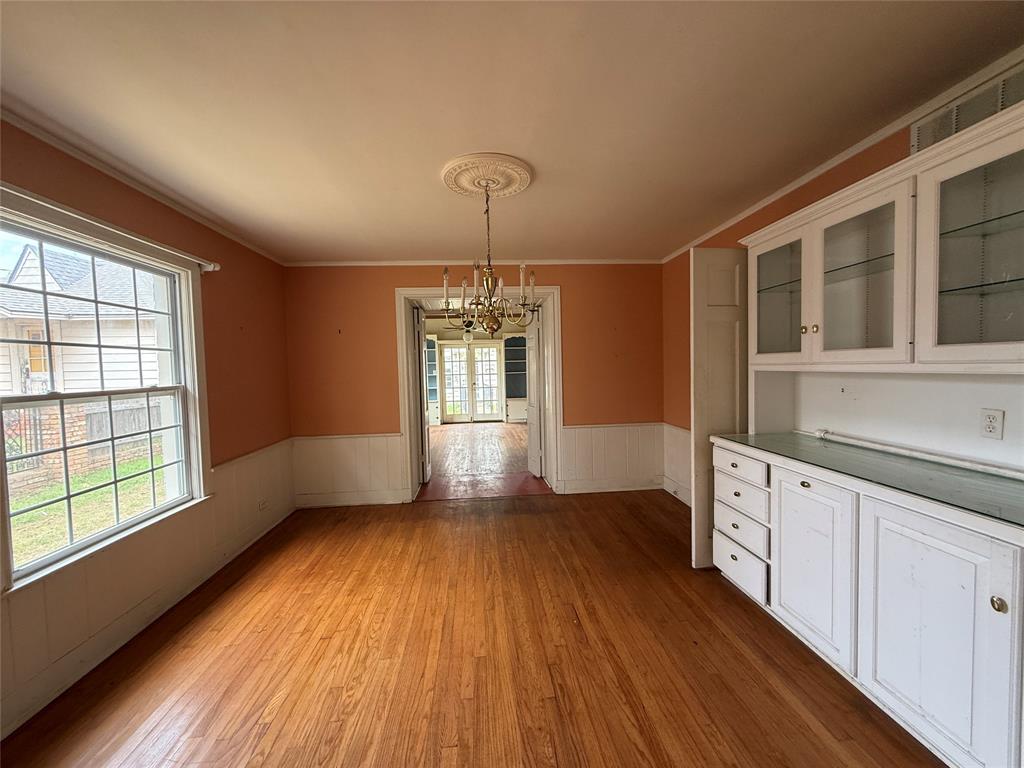 325 West 4th Street Tyler, TX 75701 - Photo 5 of 40 a view of an empty room with wooden floor and a window