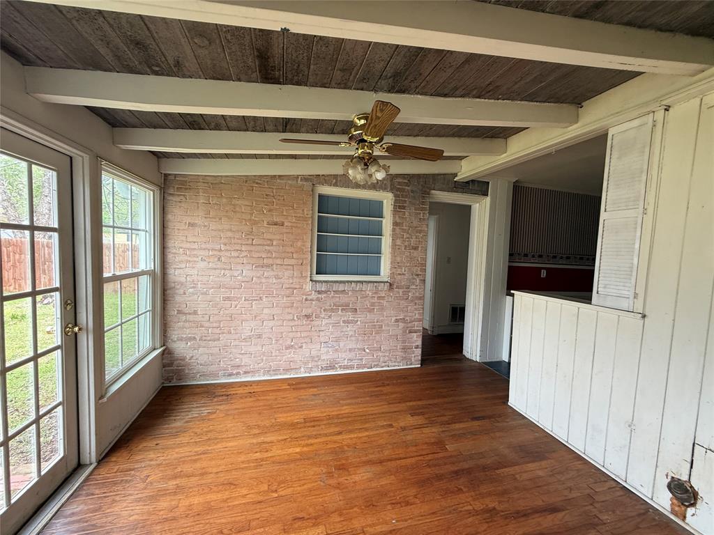325 West 4th Street Tyler, TX 75701 - Photo 8 of 40 a view of an empty room with wooden floor and a window