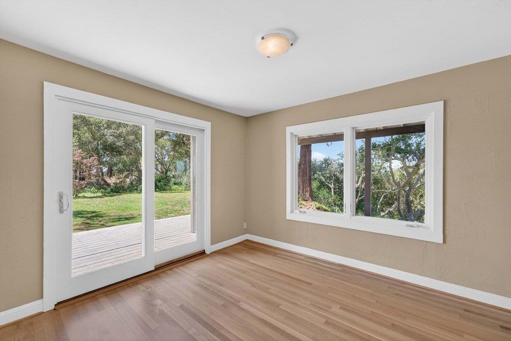 505 Hidden Valley Road Watsonville, CA 95076 - Photo 18 of 72 a view of an empty room with wooden floor and a window