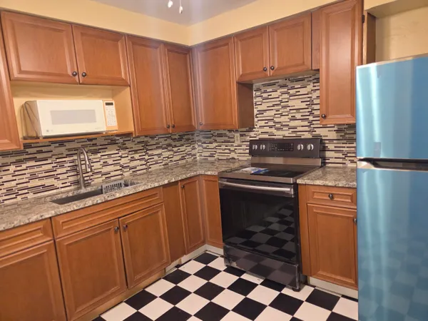 a kitchen with stainless steel appliances granite countertop a refrigerator sink and cabinets