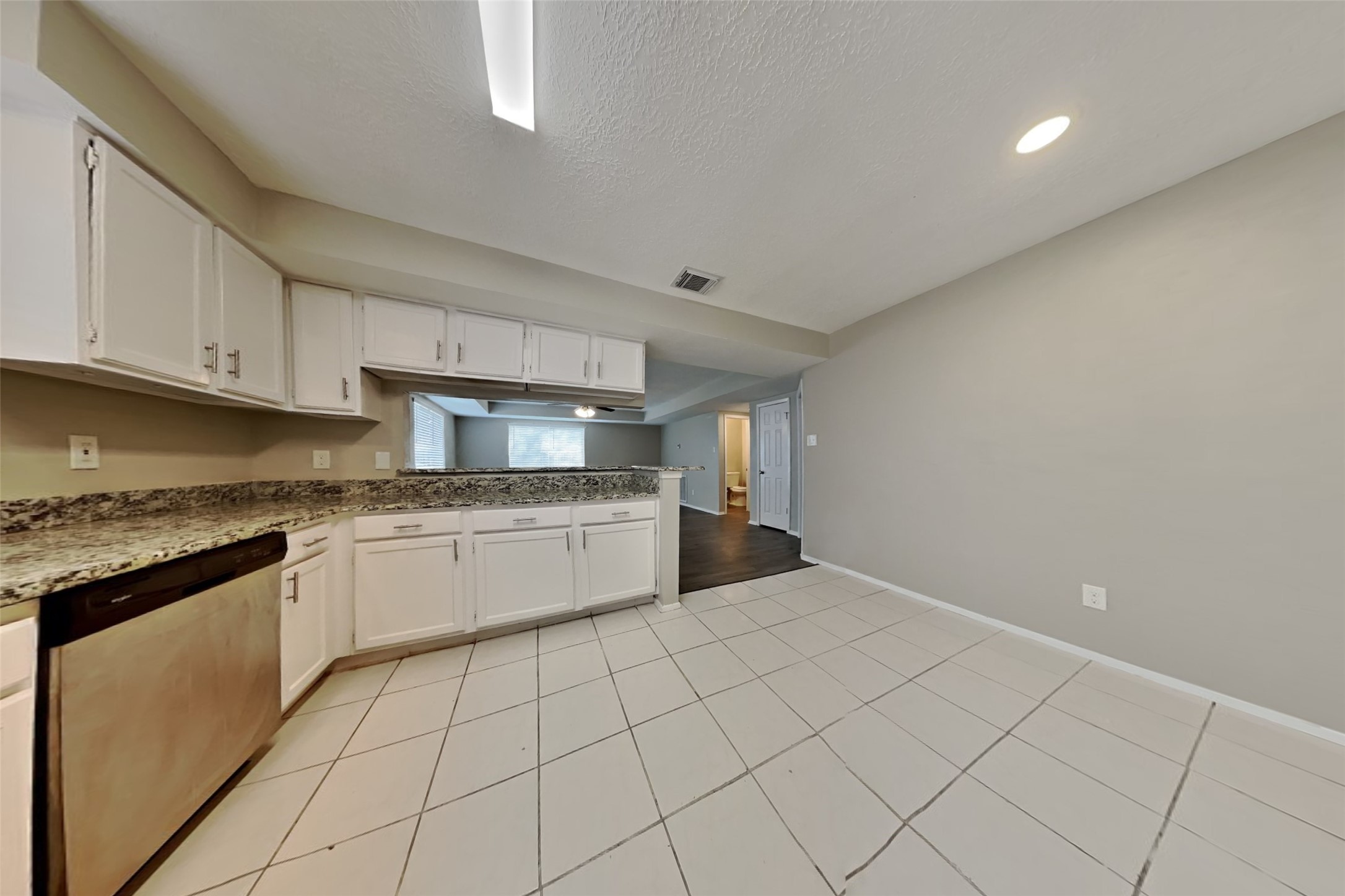 21606 Crescent Heights Street Spring, TX 77388 - Photo 8 of 23 a kitchen with granite countertop white cabinets and stainless steel appliances