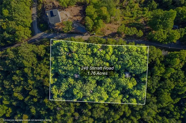 an aerial view of a house with a yard and outdoor seating