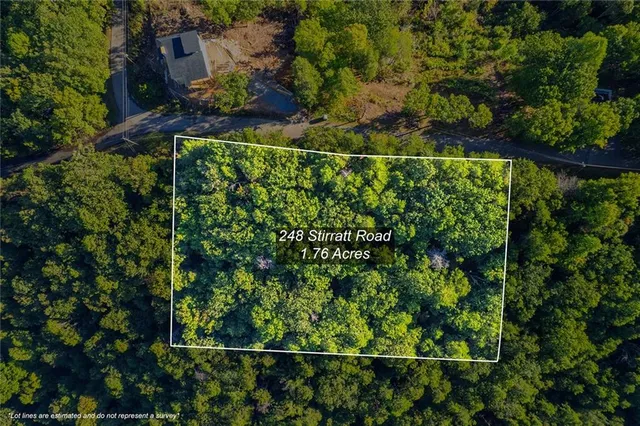 an aerial view of a house with a yard and outdoor seating