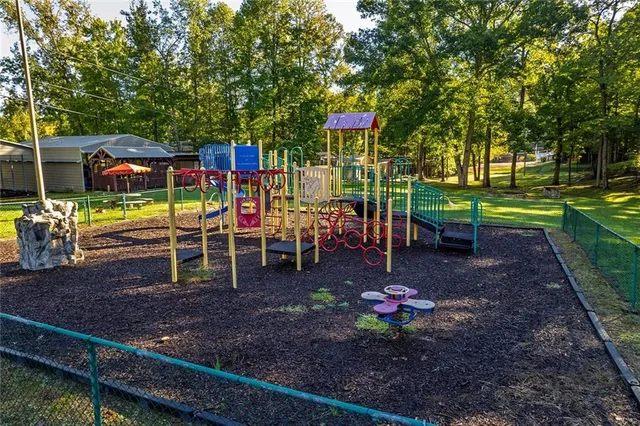 a swimming pool with some trees and big trees