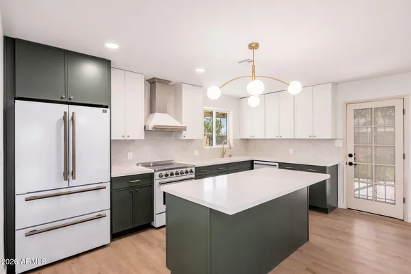 a kitchen that has a cabinets a sink and a stove in it
