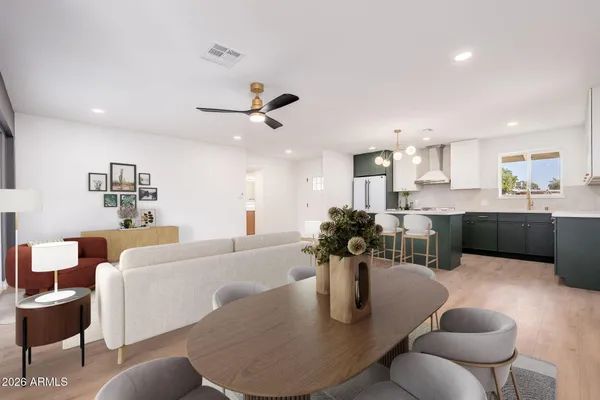 a living room with furniture kitchen view and a dining table