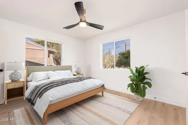 a bedroom with a large bed and a potted plant