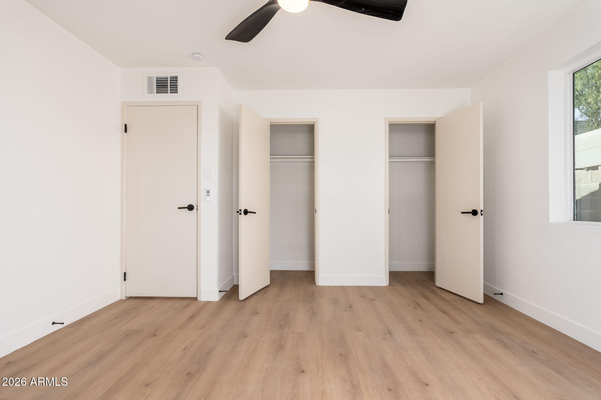 6134 North 9th Street Phoenix, AZ 85014 - Photo 17 of 36 an empty room with ceiling fan and window