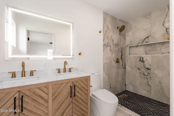 a bathroom with a sink toilet and shower