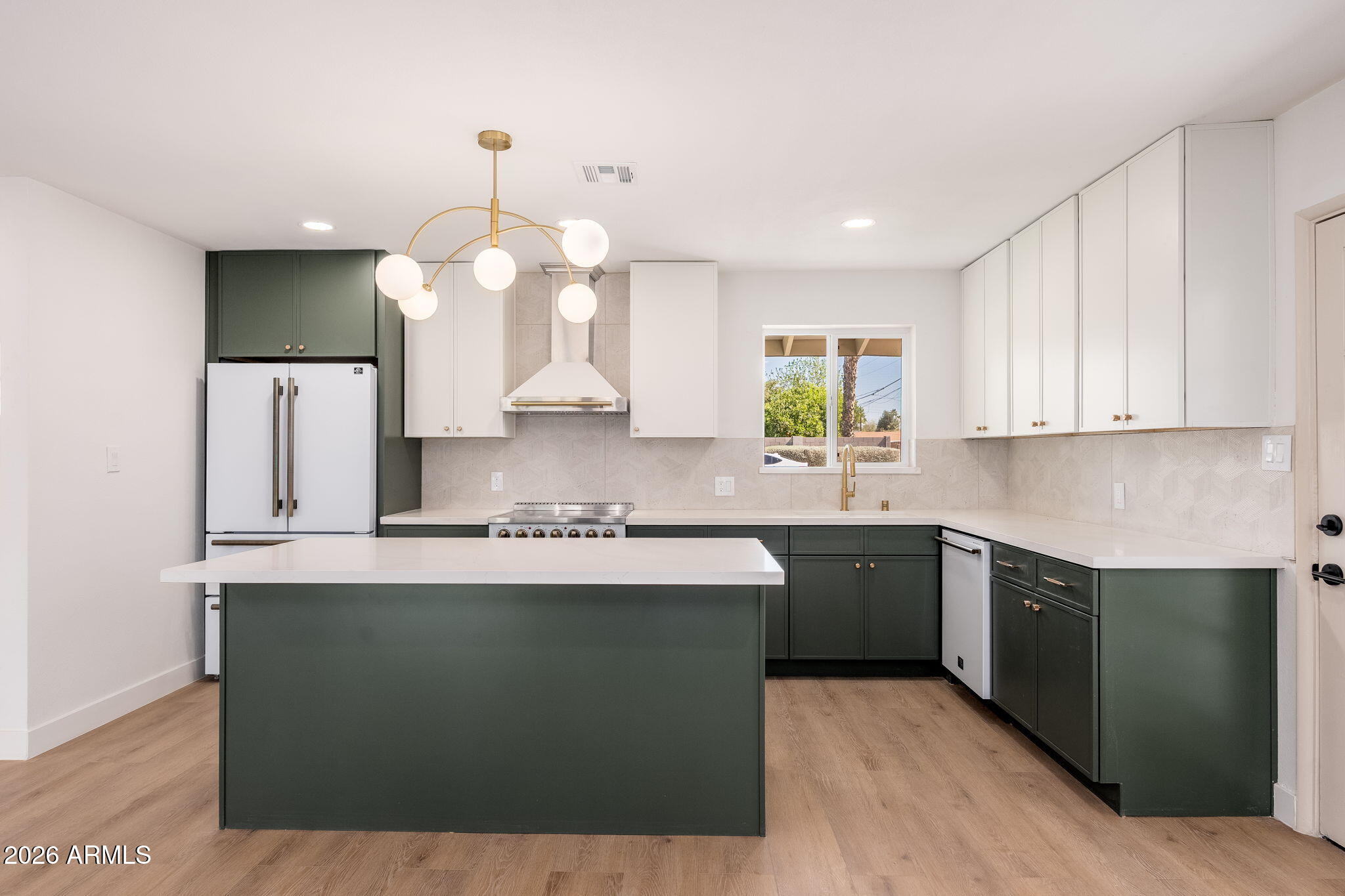 6134 North 9th Street Phoenix, AZ 85014 - Photo 2 of 36 a kitchen with kitchen island granite countertop a sink a counter top space cabinets and stainless steel appliances
